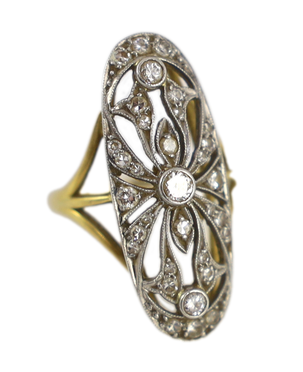 An Edwardian gold and diamond cluster set pierced up-finger ring